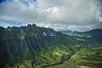 A helicopter flying along the mountains in Oahu on the Complete Island Oahu Helicopter Tour in Hawaii USA.