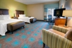 2 Queen beds, a seating area, work desk and chair, and a flat screen TV at Hampton Inn & Suites Destin. 