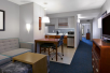 Living room and a fully-equipped kitchen at Homewood Suites by Hilton Seattle Downtown. 