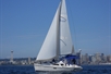 The sailboat with the city of Seattle behind it on the Private Sailing Adventure on the Puget Sound in Seattle Washington USA.