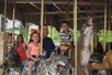 Family rides the carousel at the San Antonio Zoo