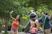 Guests take a photo with rhinoceros character