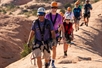 Zipline group walking through the rocky terrain on the Ultimate Zip Line Adventure Moab Utah. 