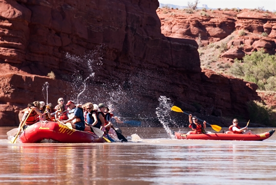 A water fight with paddles broke out between these two rafts on the Colorado River Full-Day Rafting Adventure in Moab Utah.