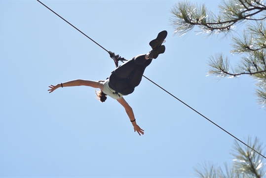 Somone mid zipline at Flagstaff Extreme Adventure Course